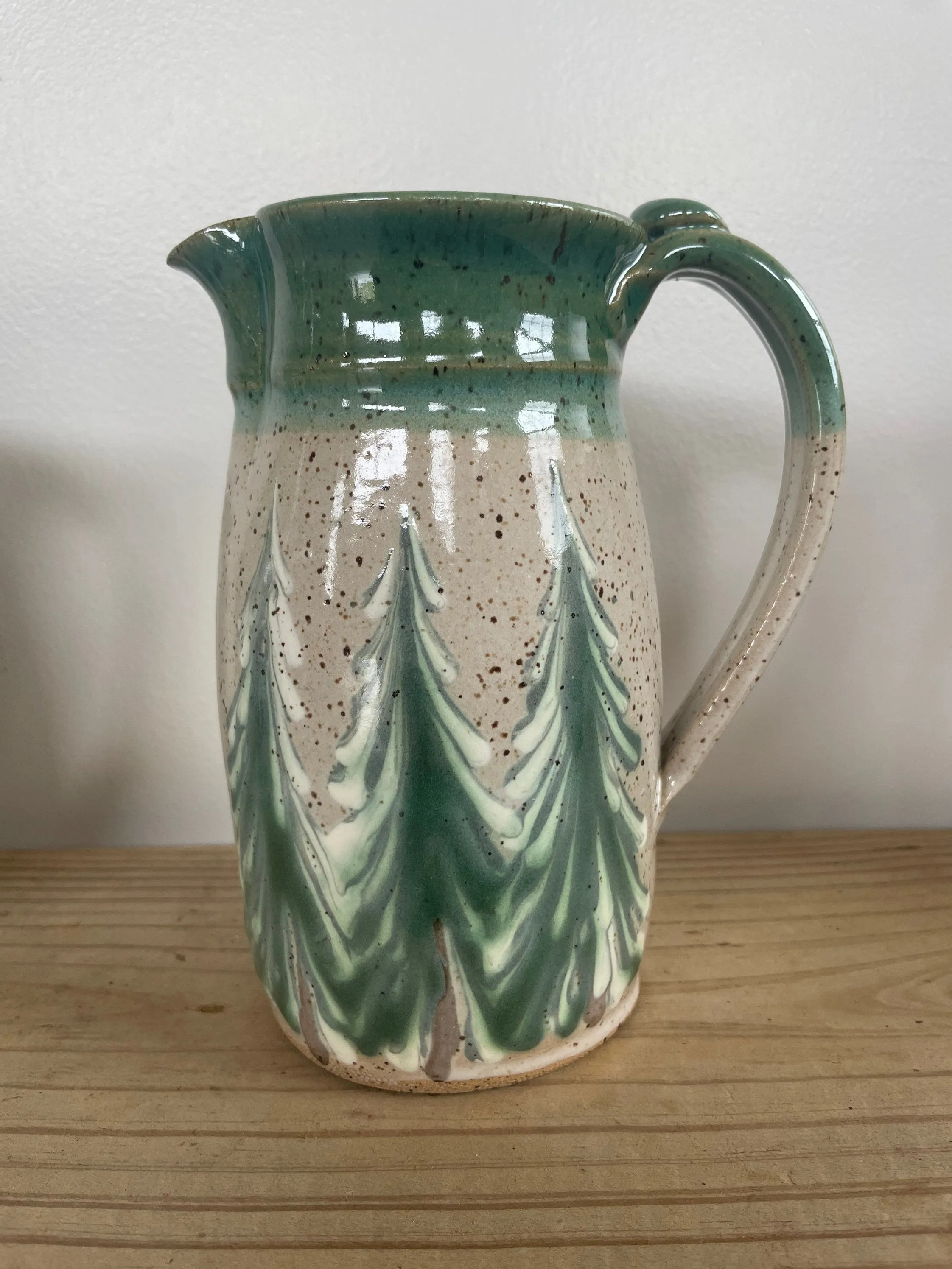 Hand thrown ceramic pitcher with winter trees