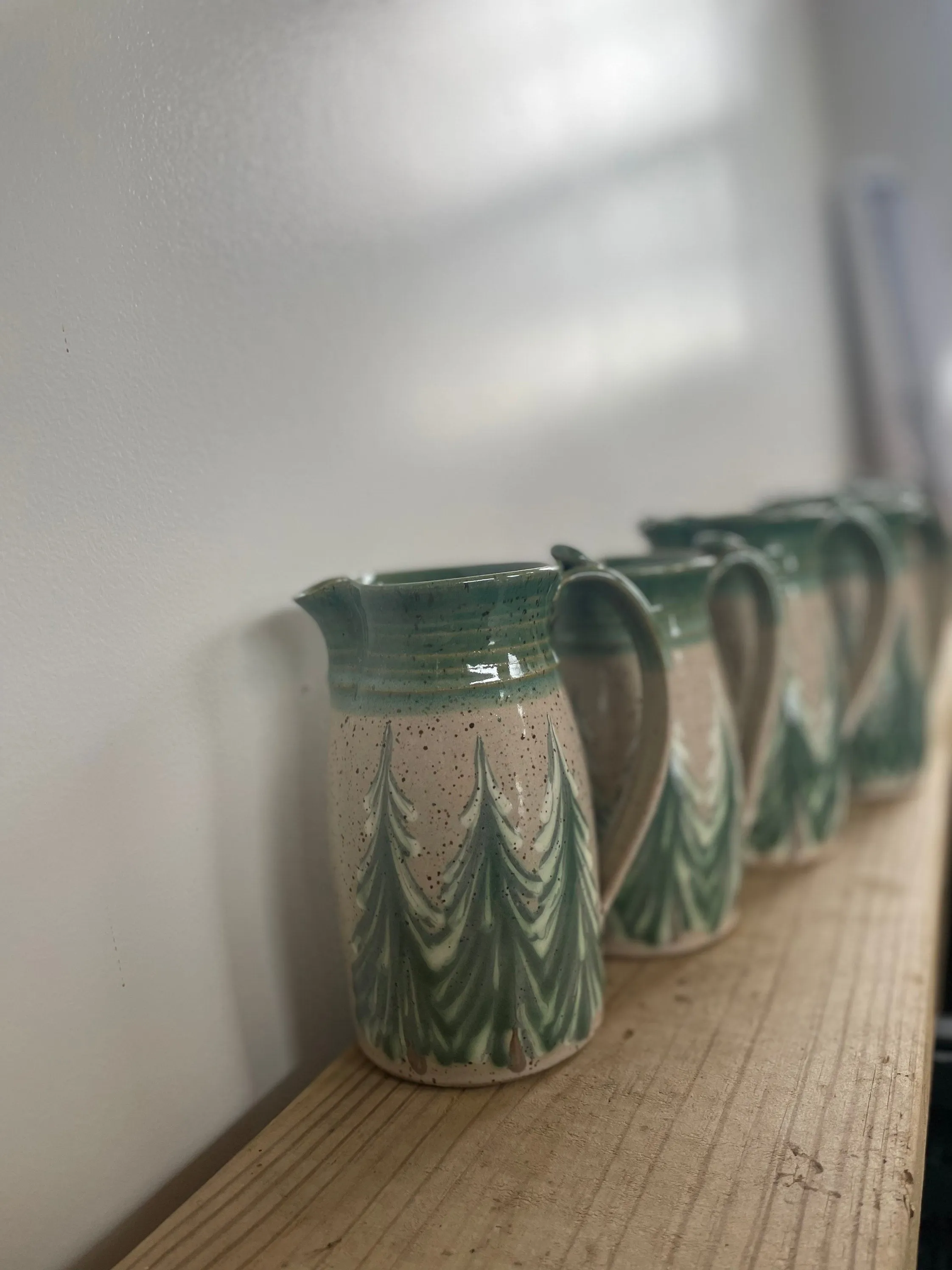 Hand thrown ceramic pitcher with winter trees