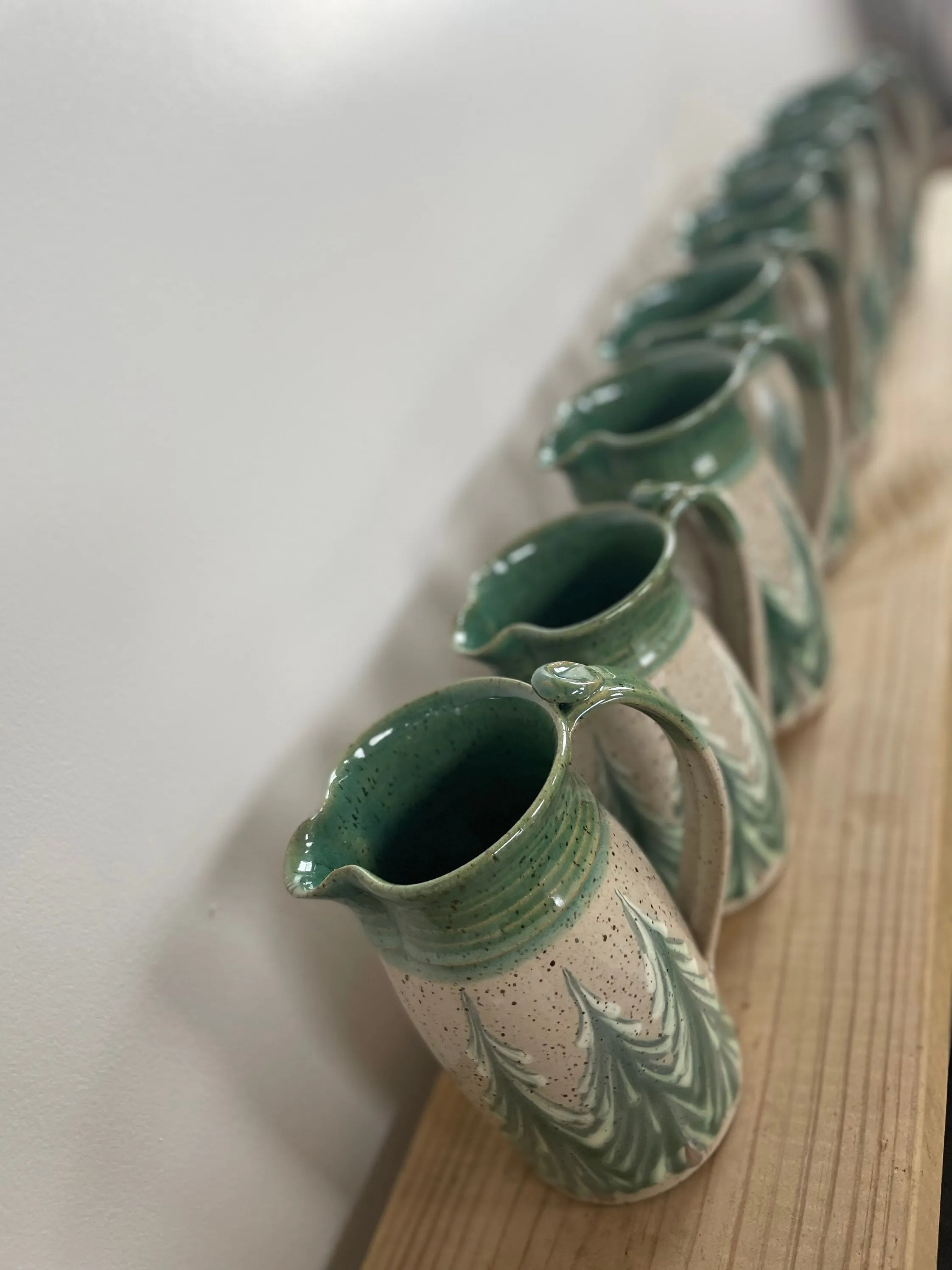 Hand thrown ceramic pitcher with winter trees