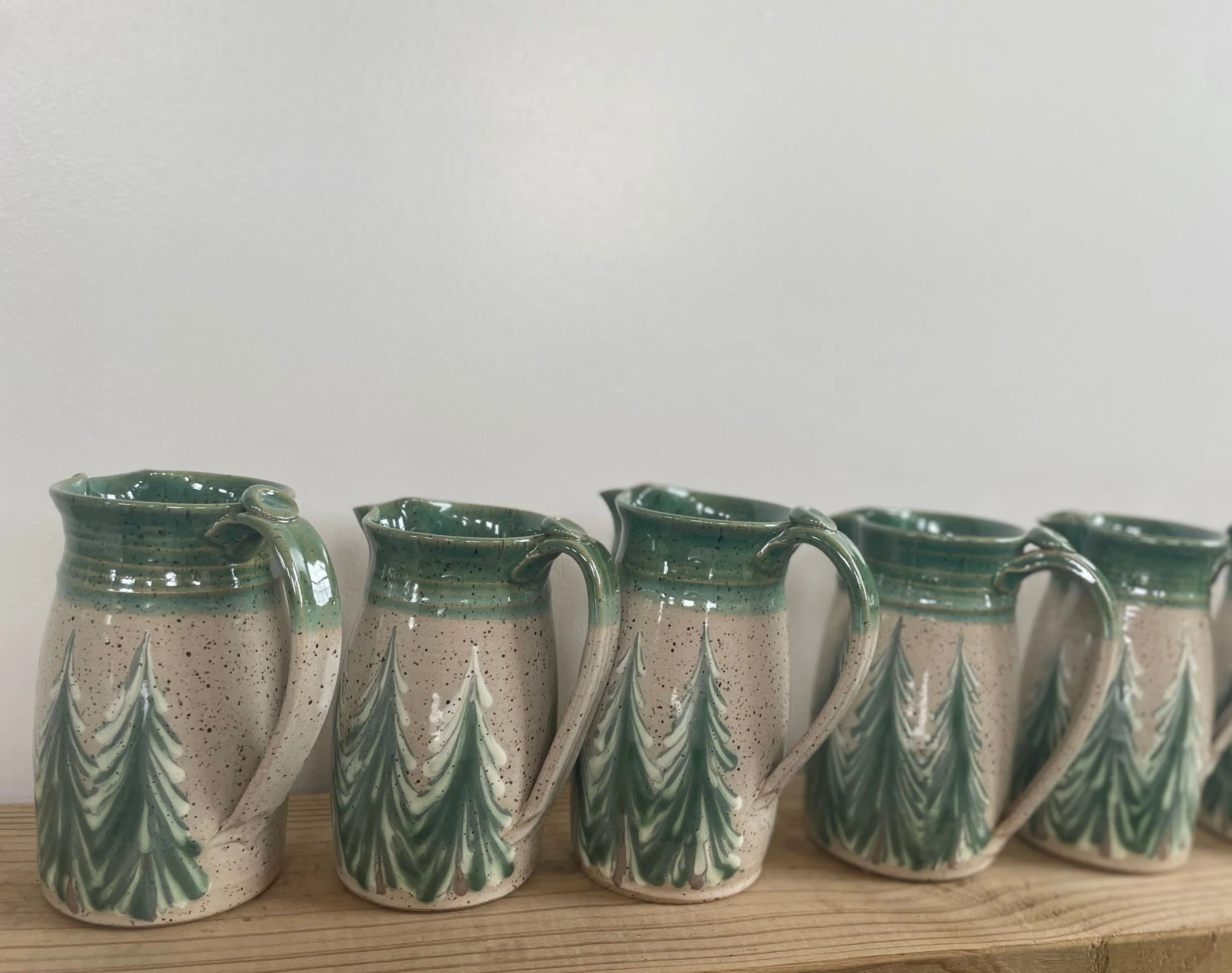 Hand thrown ceramic pitcher with winter trees